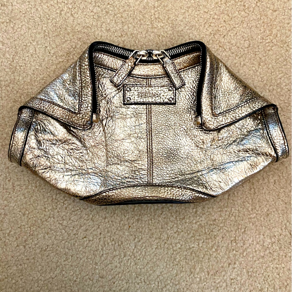 Alexander McQueen distressed gold leather clutch.